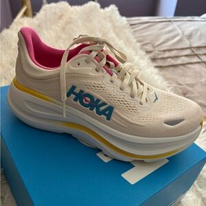Hoka Women's Cream Running Shoe with Pink Lining and Blue Logo. Brand new